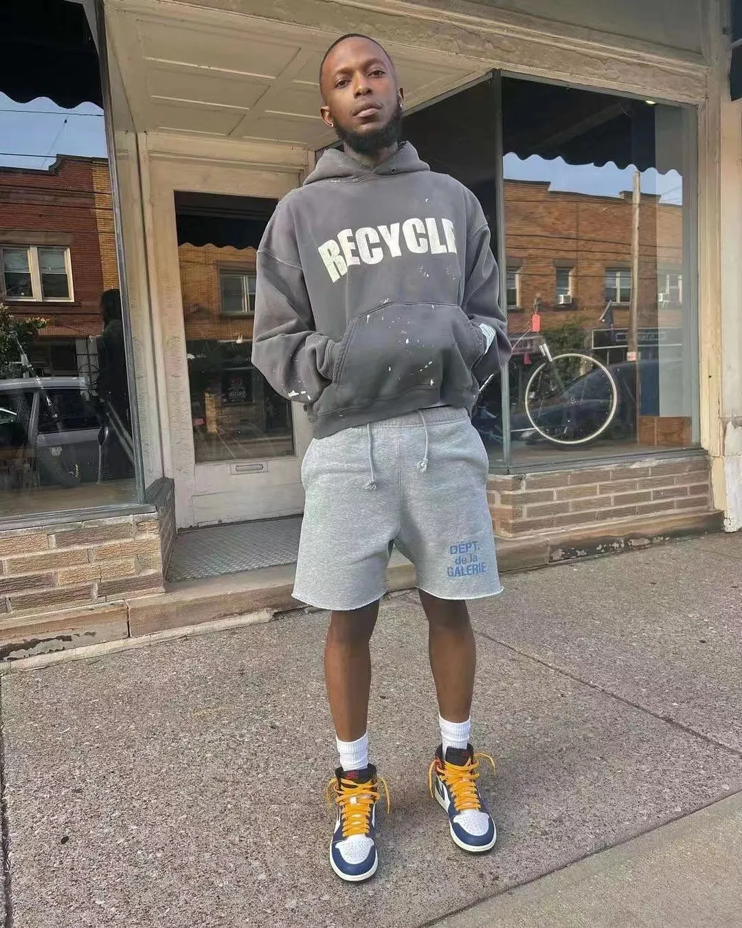 GALLERY DEPT. 90'S RECYCLE HOODIE WASHED BLACK 90'S washed hoodie with distressed eco-friendly slogans. Washed black S-XL. Ready-made garments are washed and dyed again. Multiple spots throughout the body are spray-faded. The ribs are cut and worn.